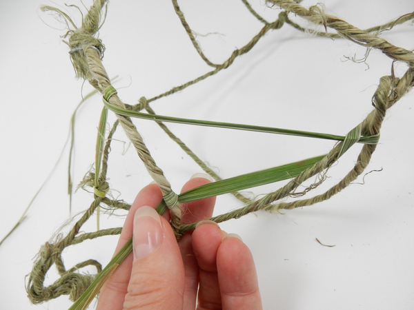 Weave a blade of grass through the structure to create the nest