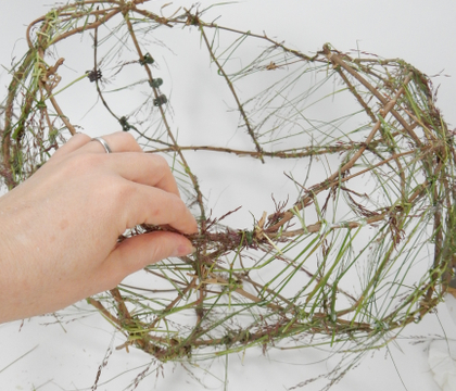 Weaving grass to create a delicate mesh cup armature