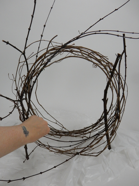 Snip away any stems that keep a vine wreath in place and loosen up the coils