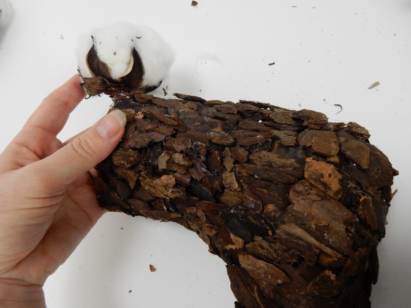 Glue a few cotton pods around the edge of the bark Christmas stocking