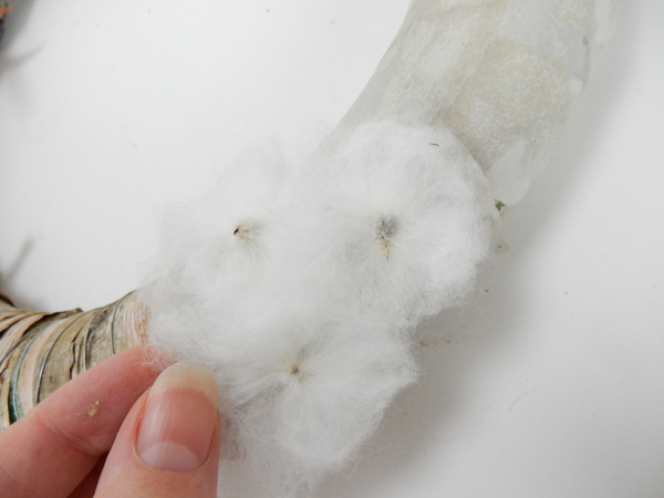 Glue the cotton disks to the wreath frame