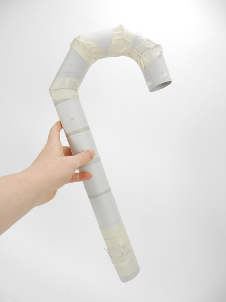 Tape a few cardboard rolls to create a basic candy cane shape