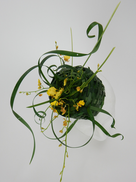 Easter bonnet woven from lily grass with oncidium orchids