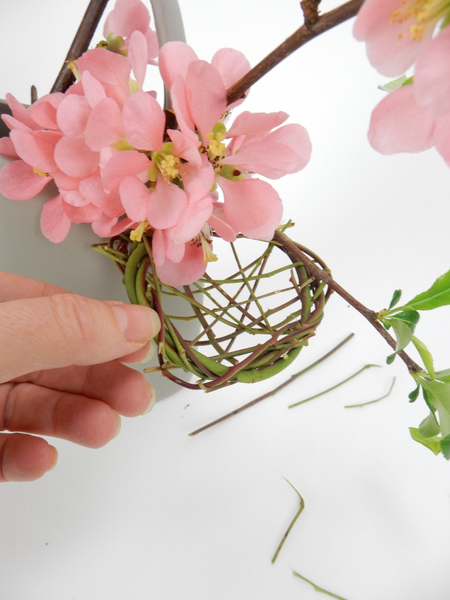 Hang the nest over the edge of a container