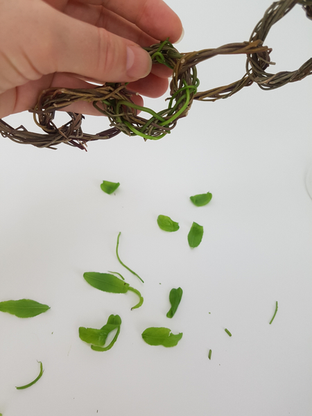 Continue adding green stems to the wreath