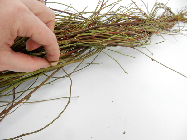 Hook your finger around individual twigs to pull it from the braid