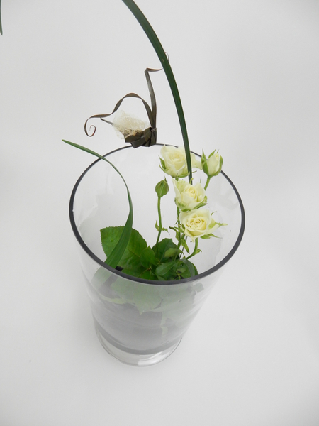 Set roses in a vase with a Kenzan