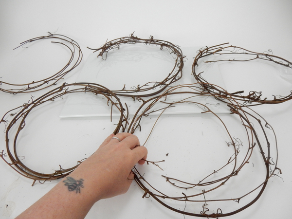 Reshape and weave the vines into smaller wreaths
