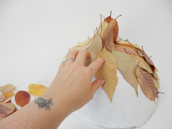 Add leaves down and around the paper shape