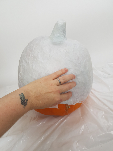 I placed about 3 layers of tissue paper on the pumpkin shape before setting it aside to dry.