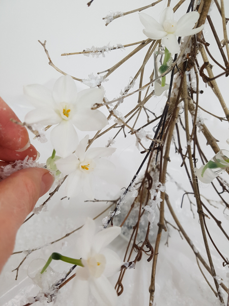 Paint the outside of the water tubes with wood glue and sprinkle with fake snow