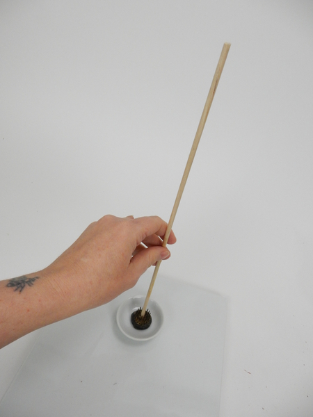Place a dowel in a small container