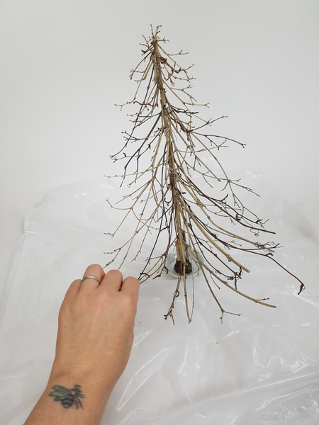 Turn the tree around and use the twigs as a guide to add twig snippets to the other side