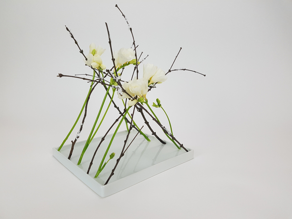 Frosted twig and freesia free standing armature design
