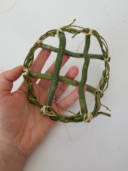 Tie four twigs across the bottom of one wreath