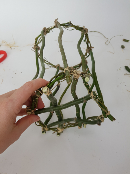 Tie those longer willow twigs to the second wreath.