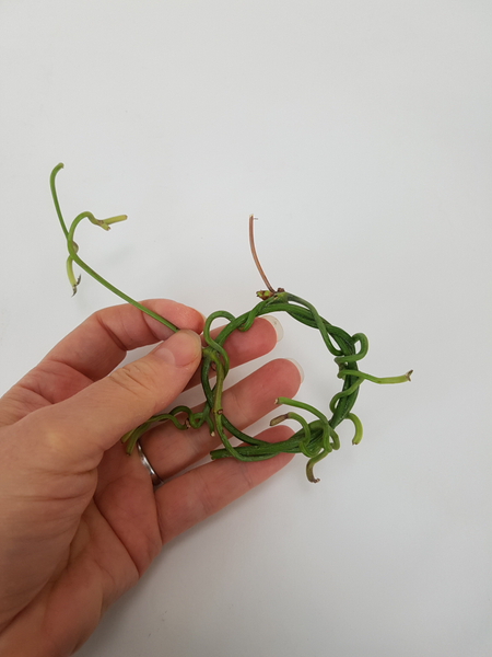 Weave the stem end tendrils into the wreath