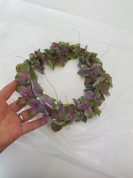 Gently lift the hydrangea wreath from the plastic