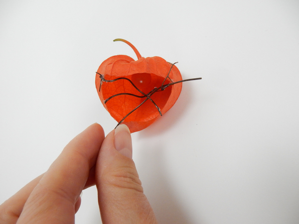 Glue in delicate twigs to craft a grid for the flowers to rest on