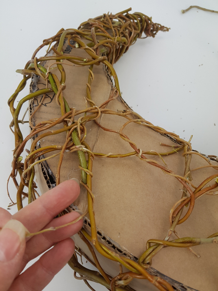 Then wrap pliable willow tips around the thicker stems to secure it in place