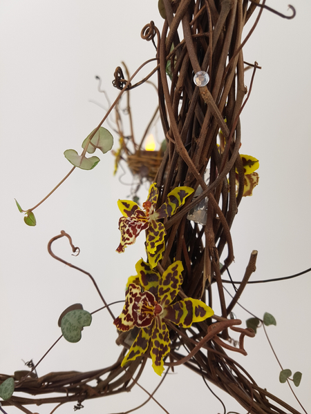 Chandelier flower arrangement with rosary vine