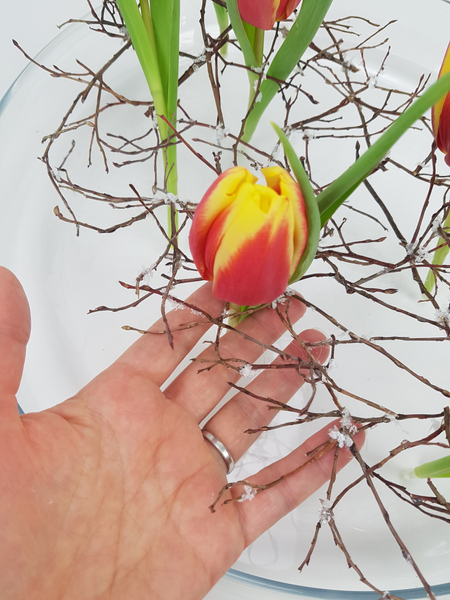 Slip the tulip stem through the twig armature Slip the tulip stem through the twig armature