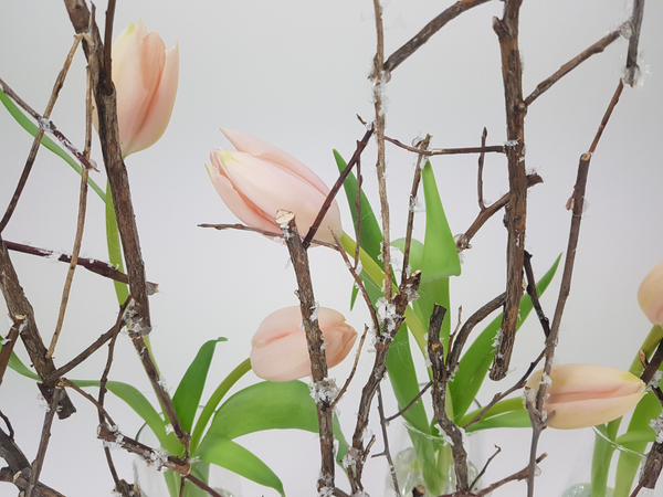 Delicate tulips in a winter floral design