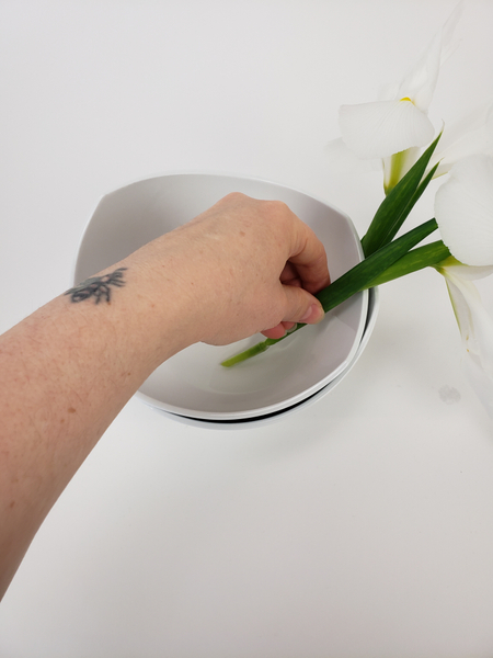 Pour water in the second bowl and place the flower stem