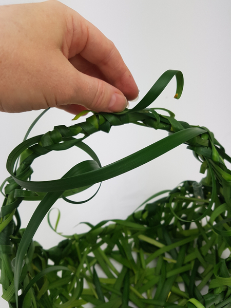 Glue in water tubes to keep the fresh flowers hydrated and add loose dangling blades of grass for a more natural look
