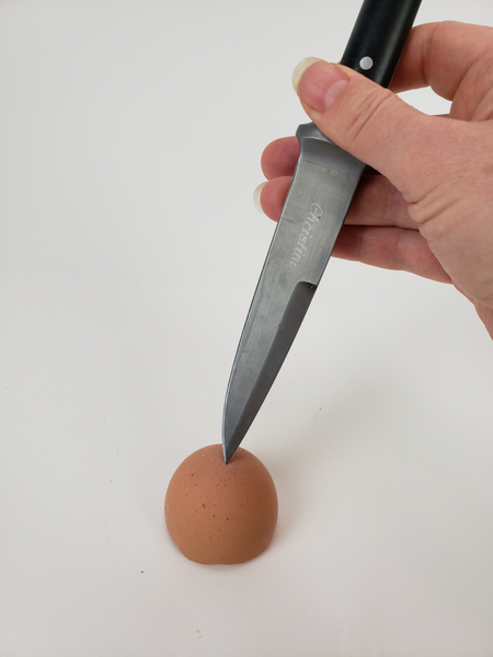 Make a hole in the bottom of an eggshell