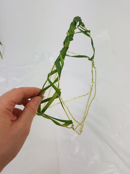 Wrap the grass around the sides of the basket leaving wide gaps