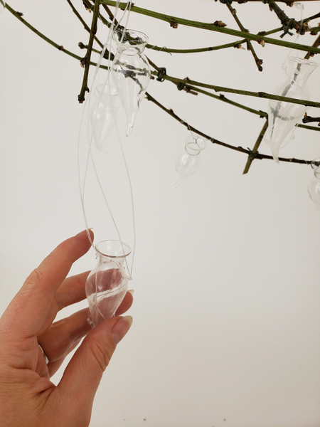 Wire or hang tiny vases to keep the fresh flowers hydrated.
