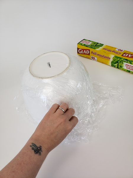 Cover a large mixing bowl with plastic wrap