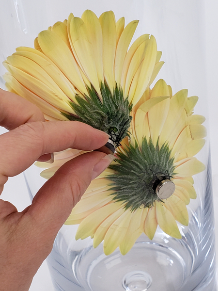 Gently move the flower from the outside by wiggling the magnet
