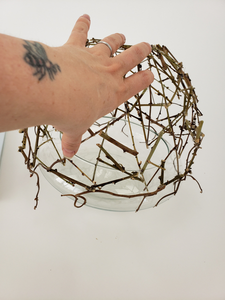 Place the twig dome over a glass container