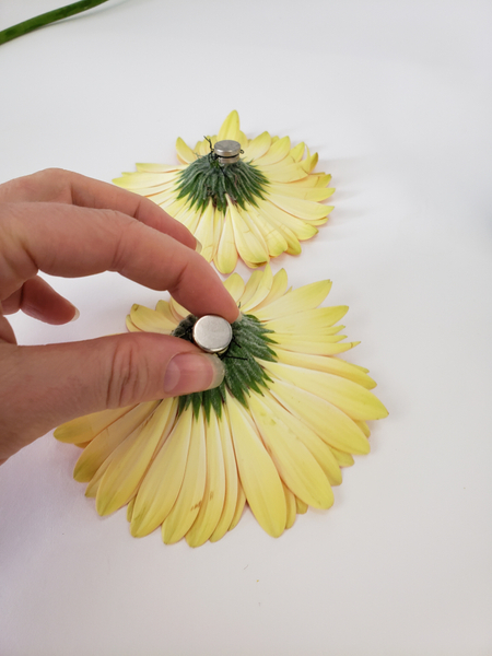 Tiny magnets keep the flowers in place under the water.