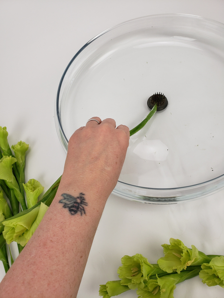 Start placing the middle stem with the largest open flowers