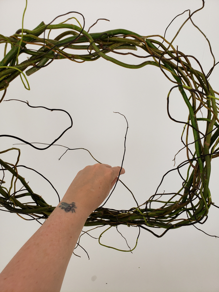 Add in a few thinner twigs where you see gaps so that the wild willow tips extend all around the wreath
