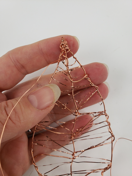 Frame the leaf by wrapping the edge with a thinner copper wire