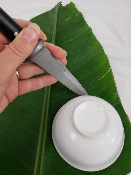 Place a small bowl on the leaf and cut a disk out with a sharp knife
