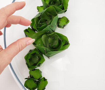 Stack banana leaf rice pockets to float as rosettes