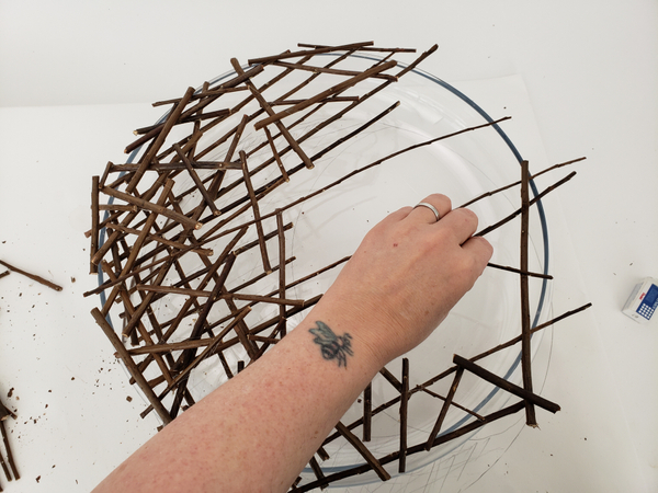Extend a few twigs over the disk shape so that you can complete the circle on the lighter side Extend a few twigs over the disk shape so that you can complete the circle on the lighter side