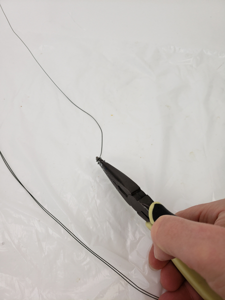 Twist the end of your wire with pliers into a loop