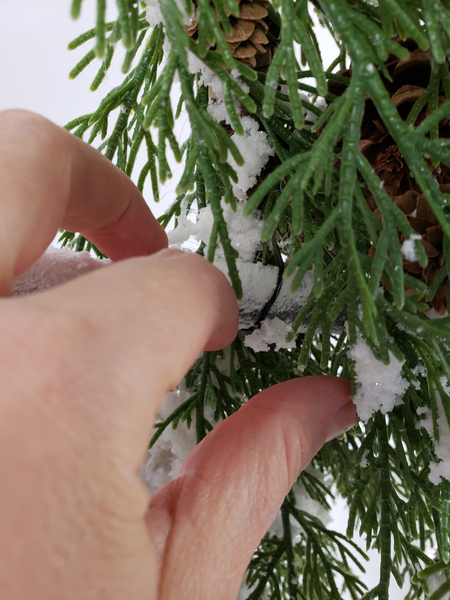 Make sure the wire is not visible by securing it behind the branches.