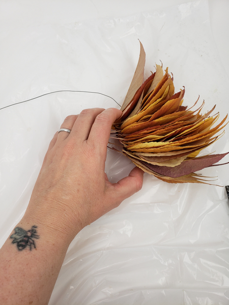 Thread a stack of autumn leaves with wire.