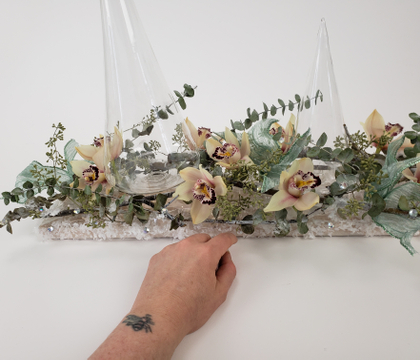 Create a centerpiece foundation with lumber and the cellophane your flowers were wrapped in