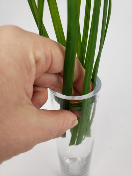 Push the circle back into the bud vase to keep the grass in place