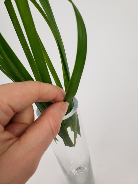 Slip the grass end into the vase so that it can remain hydrated