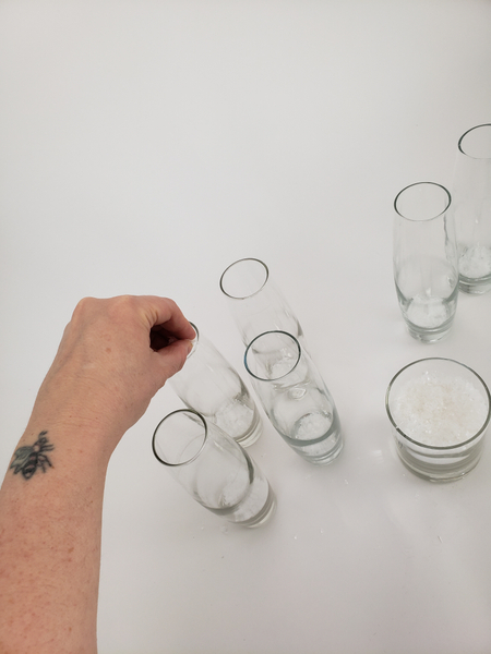 Sprinkle a tiny bit of artificial snow in six bud vases