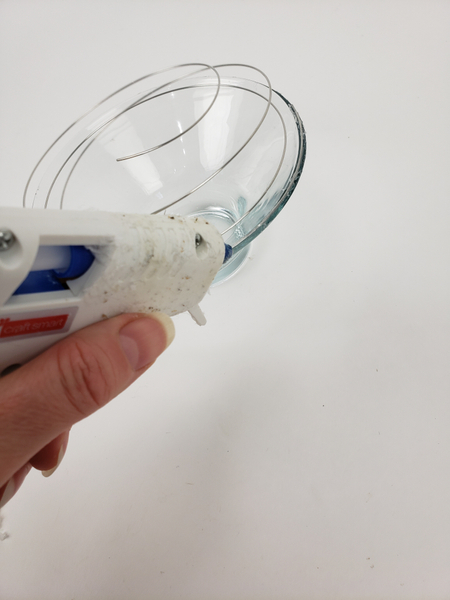 Glue the wire to the container using hot glue